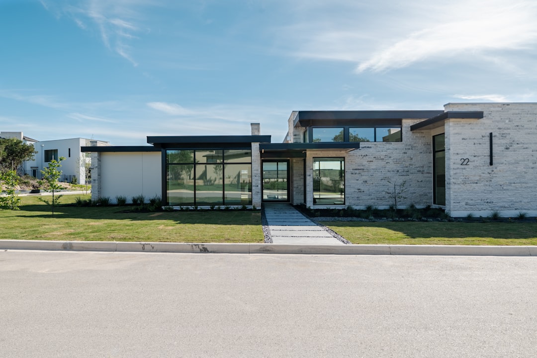 A professional real estate agent uses a tablet to discuss a property inside a bright, modern living room, showcasing technology-driven, full-service brokerages.