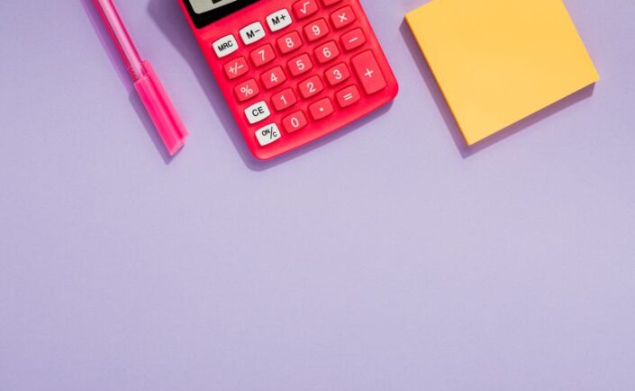 Bright, professional desk scene with a calculator and house keys, symbolizing the financial aspects of negotiating real es...